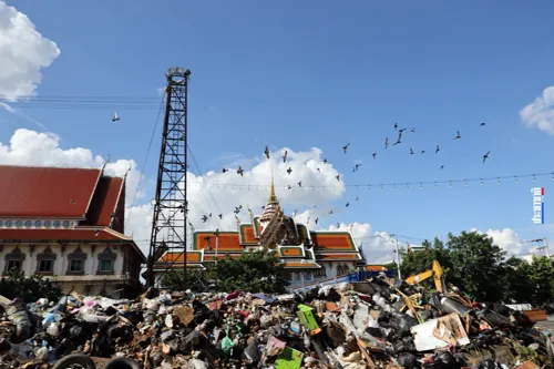 Bangkok moves flood debris from Wat Bueng Thonglang to a new drop-off point at Hua Mum market
